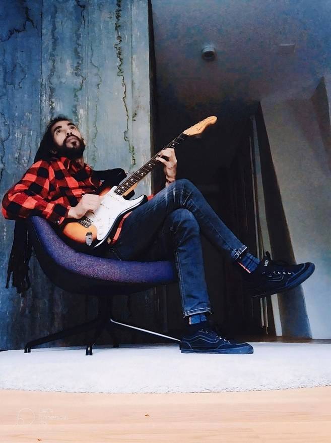 Amine seated with an electric guitar