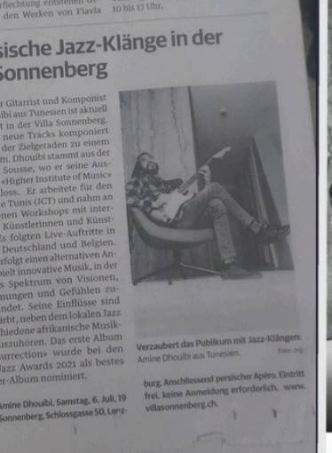 Swiss newspaper clipping featuring Amine with his guitar at Villa Sonnenberg